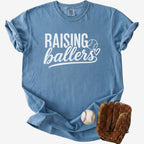 Blue t-shirt with 'RAISING ballers' text, baseball, and glove on a white background
