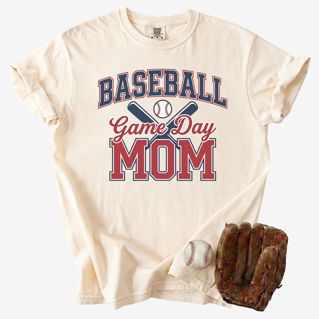 Beige t-shirt with 'Baseball Game Day Mom' text, baseball, and glove on a white background