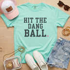 Chalky Mint Hit The Dang Ball baseball mom tee on Comfort Colors shirt styled with baseball accessories, denim shorts, and white sneakers.