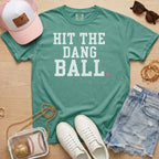 Light green Hit The Dang Ball baseball season tee styled with denim shorts, clear baseball bag, sneakers, and sideline mom accessories.