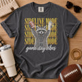 Charcoal gray football mom shirt, Comfort Colors Pepper, styled in a game day flat lay with a football and a raccoon holding a football and tumbler beneath “Sideline Mode” lettering.