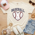 baseball mom shirt ivory graphic tee styled with glove and baseball flat lay