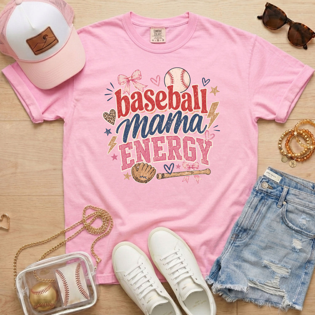 Baseball Mama Energy Comfort Colors blossom pink baseball mom shirt styled as flat lay with trucker hat, sunglasses, denim shorts, and sneakers