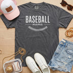 Baseball Mama shirt in pepper grey Comfort Colors 1717 featuring white block lettering and baseball stitch graphic