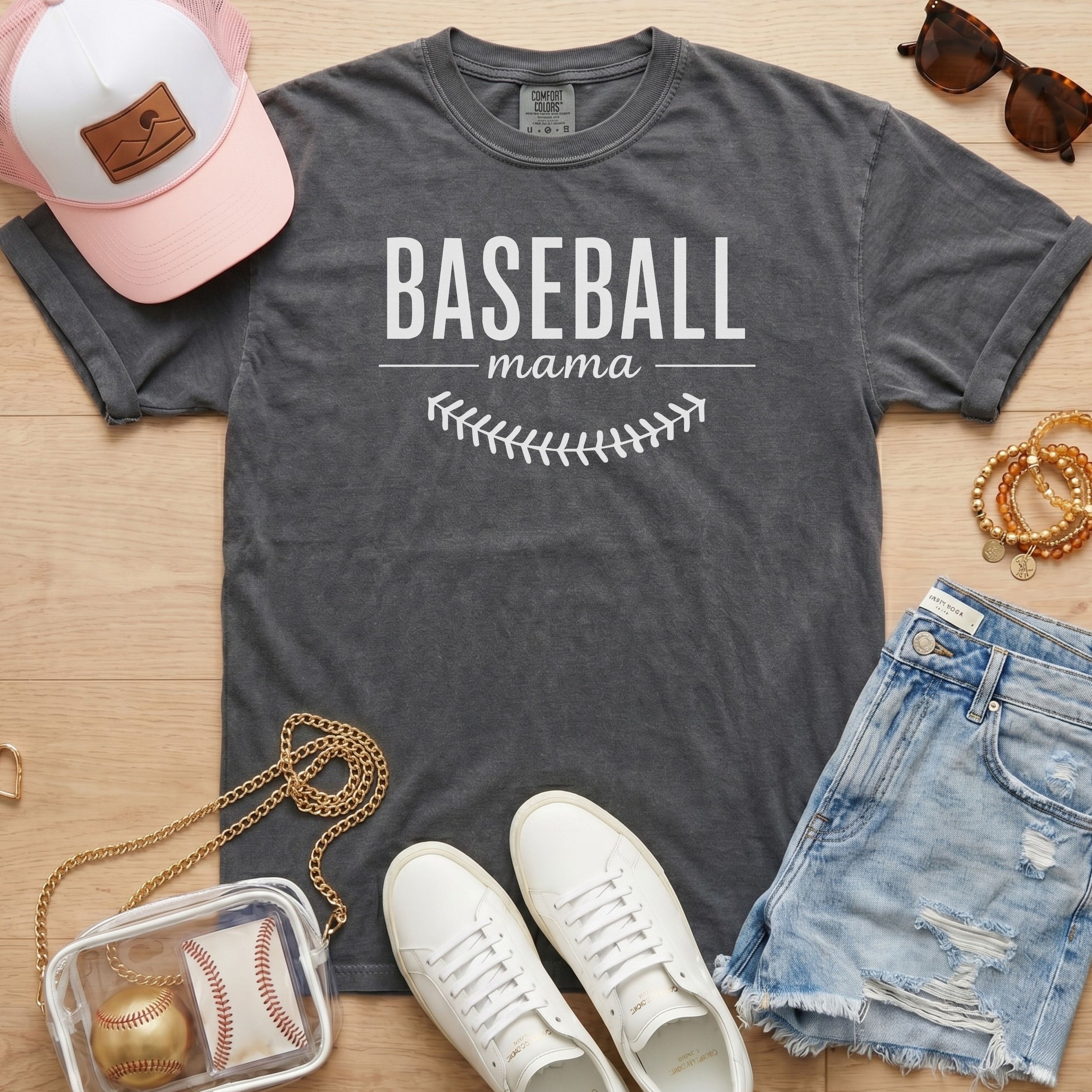 Baseball Mama shirt in pepper grey Comfort Colors 1717 featuring white block lettering and baseball stitch graphic