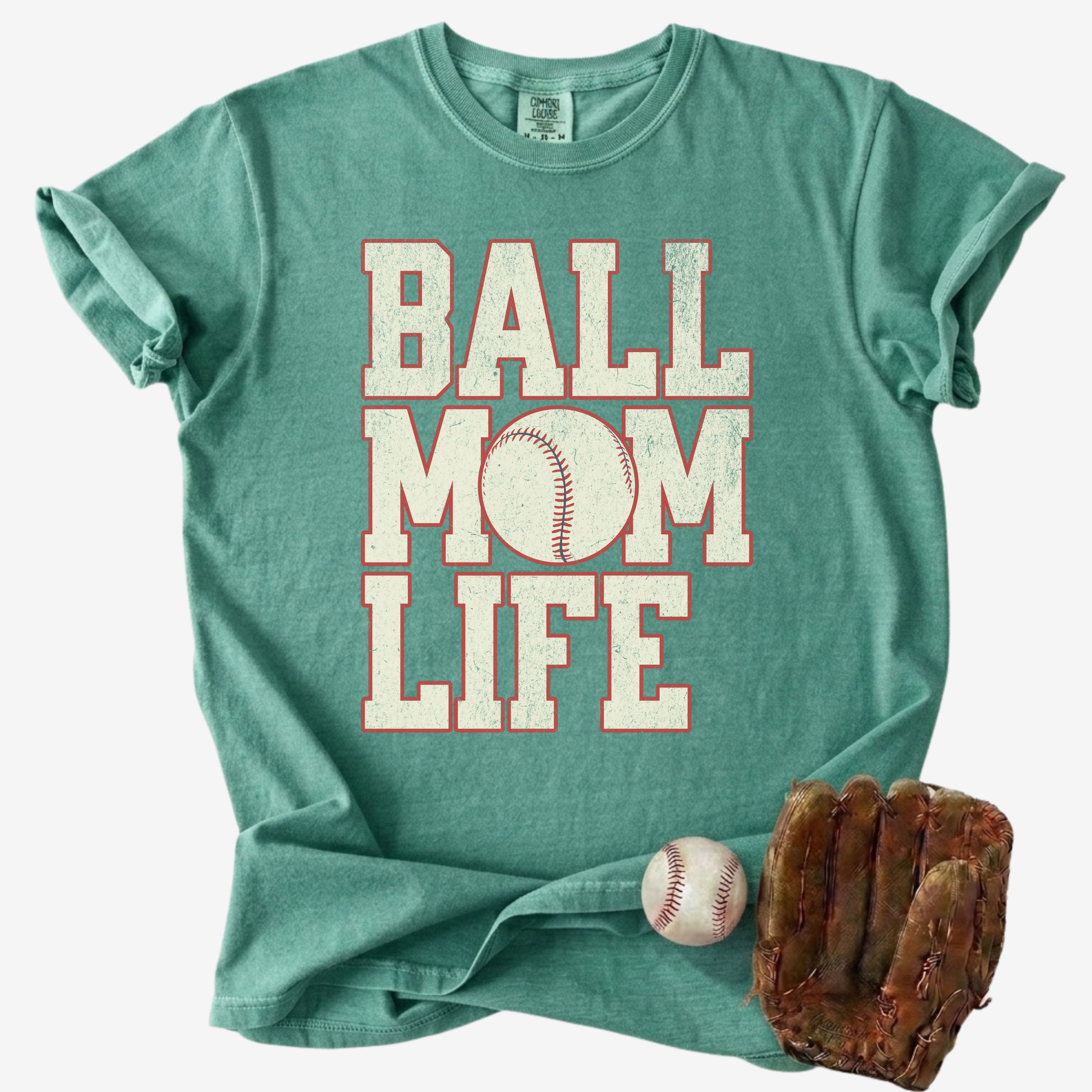 green baseball mom life shirt with vintage lettering and baseball graphic styled with glove and ball