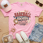 Baseball Moms Club Comfort Colors tee in blossom light pink flat lay with trucker hat, denim shorts, white sneakers, and baseball.