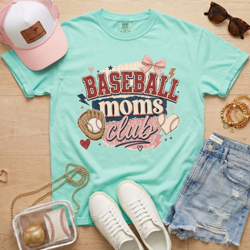 Baseball Moms Club Comfort Colors tee in chalky mint flat lay with trucker hat, denim shorts, white sneakers, and baseball.