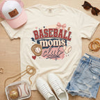 Baseball Moms Club Comfort Colors tee in ivory flat lay with trucker hat, denim shorts, white sneakers, and baseball.