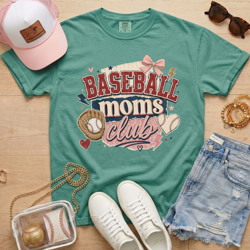 Baseball Moms Club Comfort Colors tee in light green flat lay with trucker hat, denim shorts, white sneakers, and baseball.