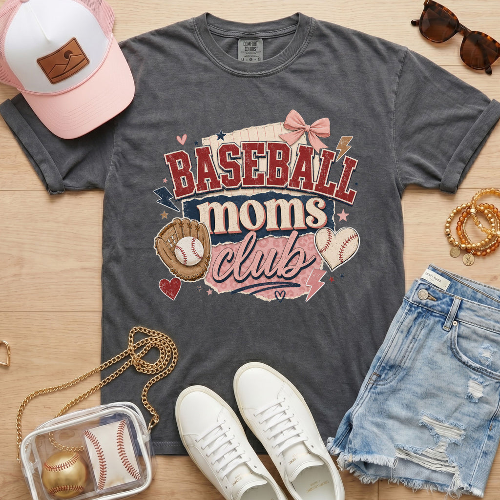 Baseball Moms Club Comfort Colors tee in pepper charcoal flat lay with trucker hat, denim shorts, white sneakers, and baseball.