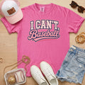 I CAN'T. Baseball. baseball mom Comfort Colors crunchberry tee in a baseball mom flat lay with pink hat, sneakers, denim shorts, and baseball bag.