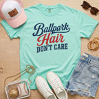 Chalky Mint Ballpark Hair Don’t Care funny baseball mom tee on Comfort Colors shirt styled with baseball accessories, denim shorts, and white sneakers.