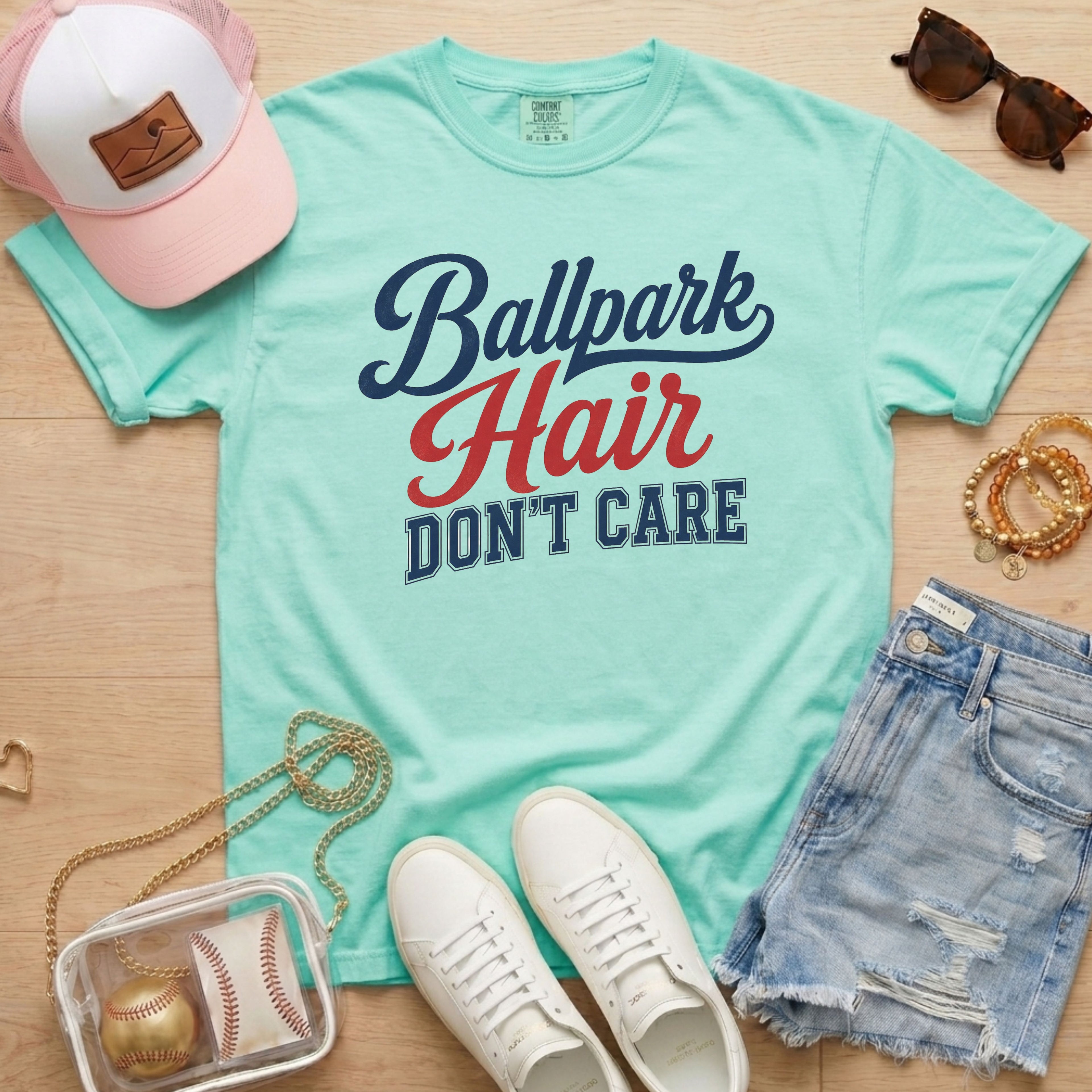 Chalky Mint Ballpark Hair Don’t Care funny baseball mom tee on Comfort Colors shirt styled with baseball accessories, denim shorts, and white sneakers.