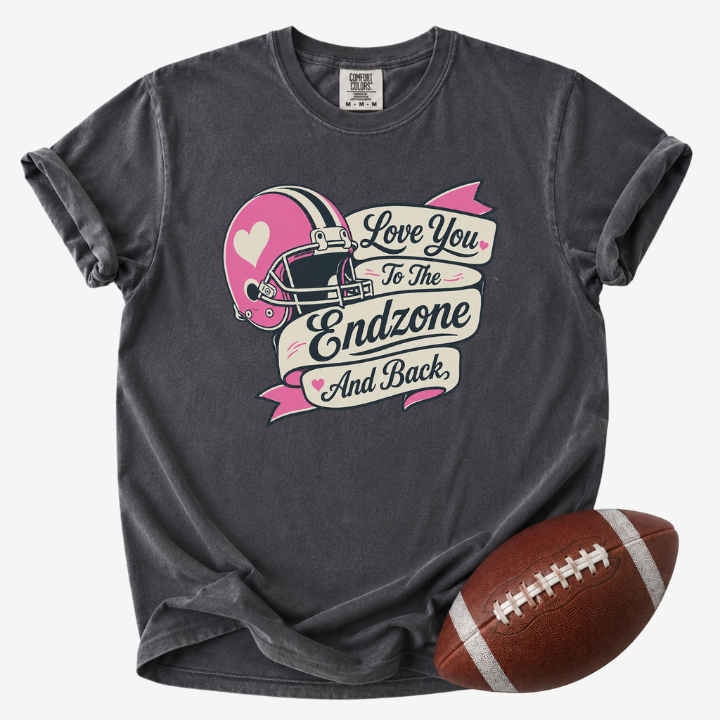 Retro football mom graphic T-shirt in charcoal gray, Comfort Colors Pepper, shown from the front with a football and pink endzone design.