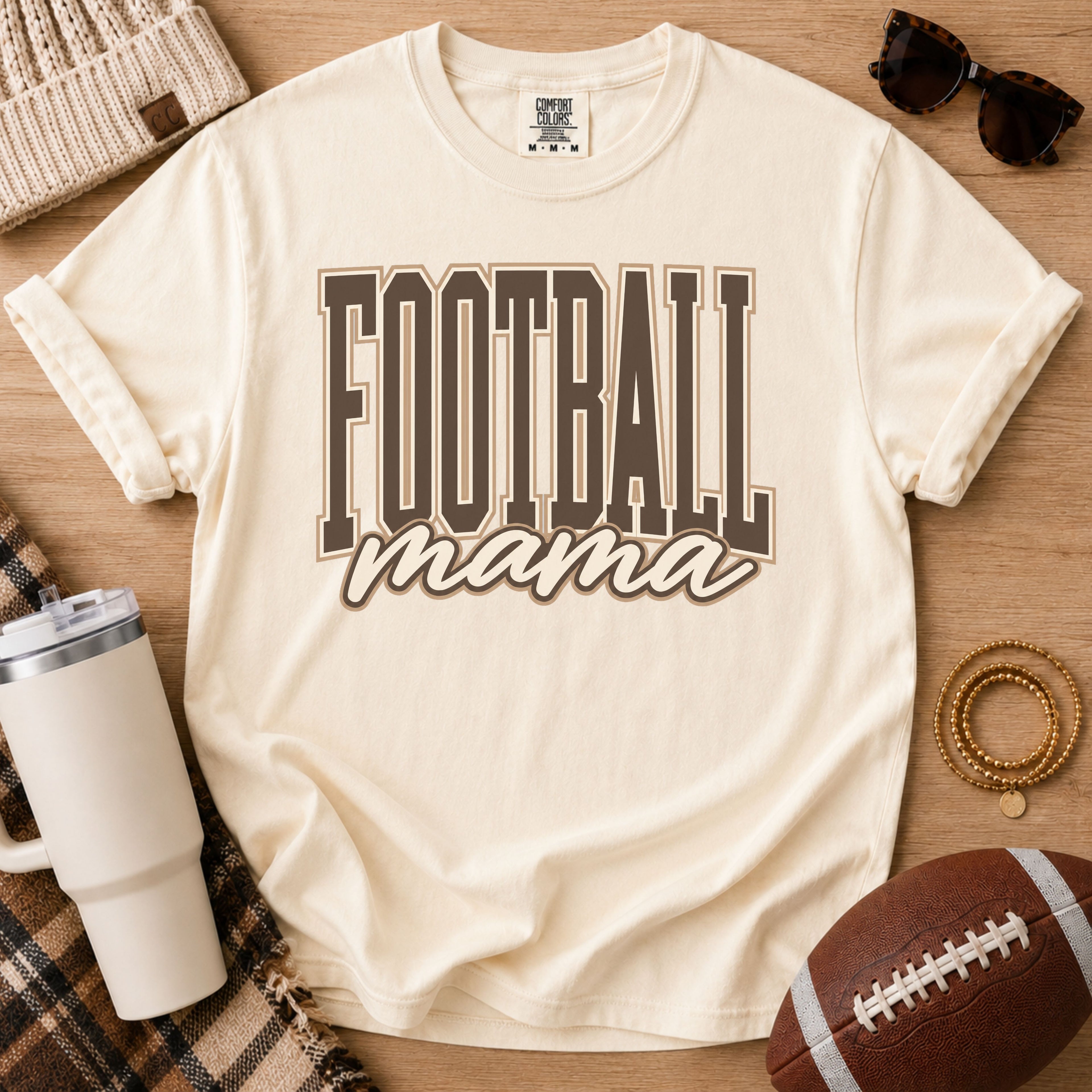 Ivory Comfort Colors football mama shirt with brown varsity design for game day.