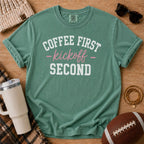 Light Green Comfort Colors football mom shirt with Coffee First Kickoff Second design and football prop.