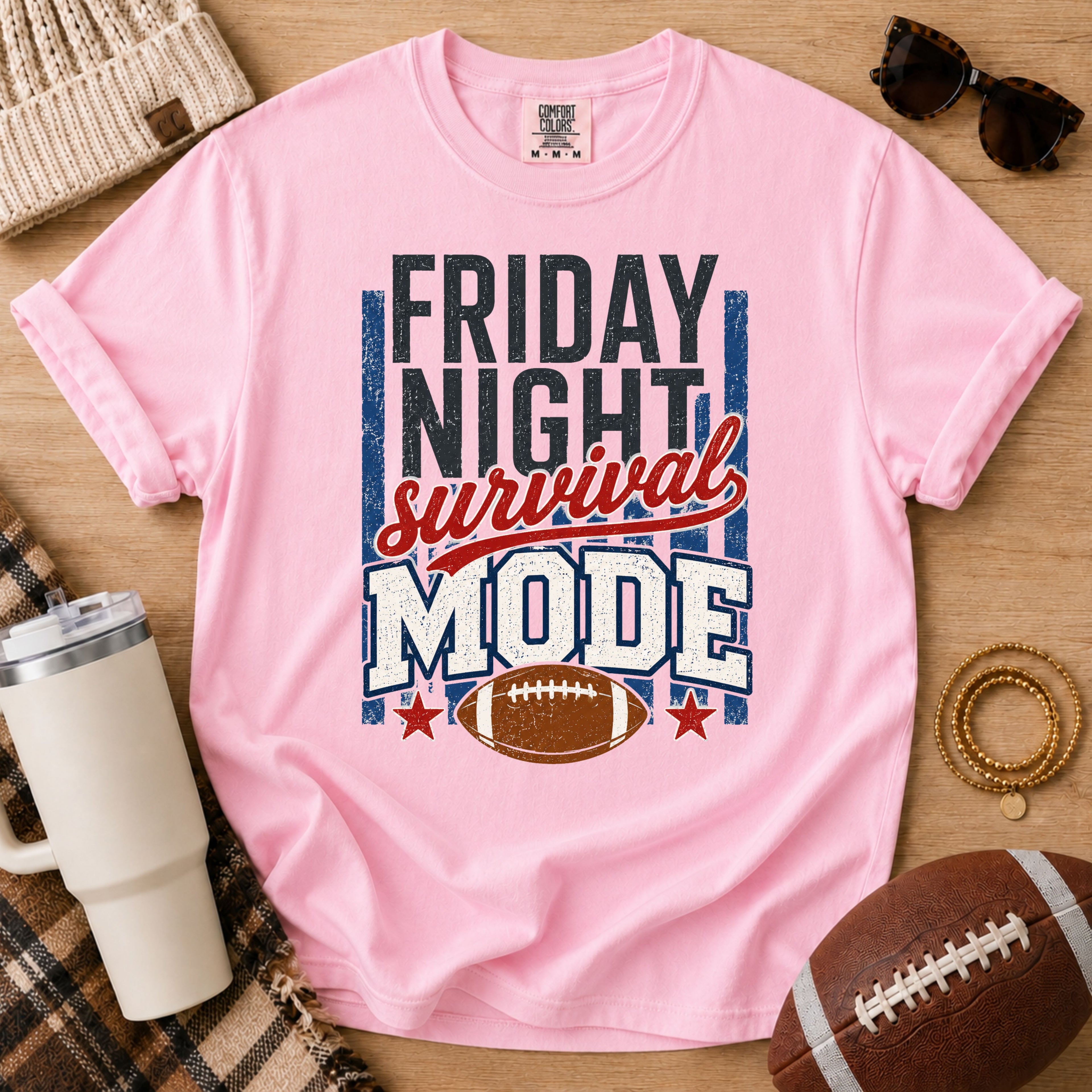 Blossom football mom shirt with Friday Night Survival Mode design on a game day flat lay.