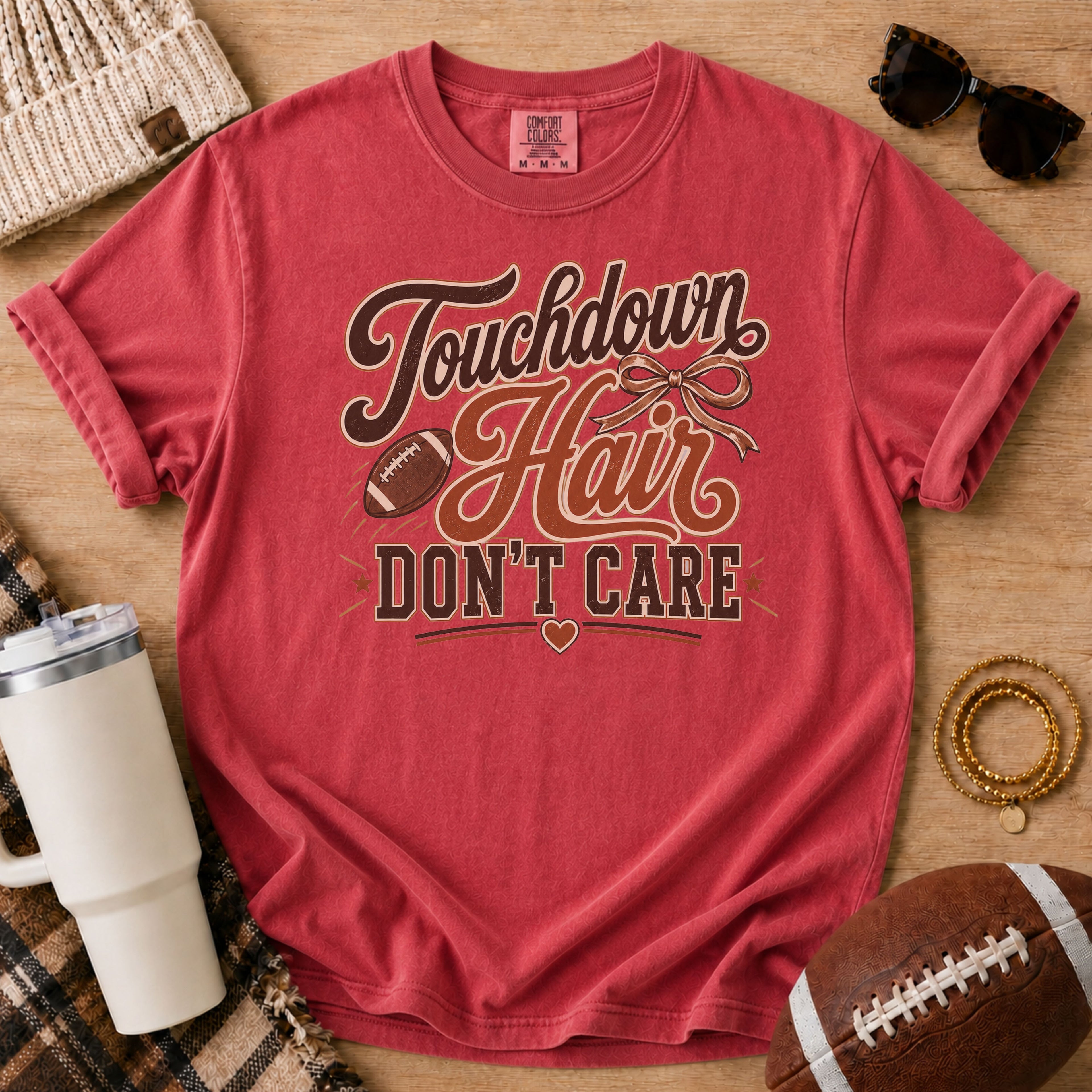 Crimson Comfort Colors football mom shirt with muddy football cleats design for youth football season.
