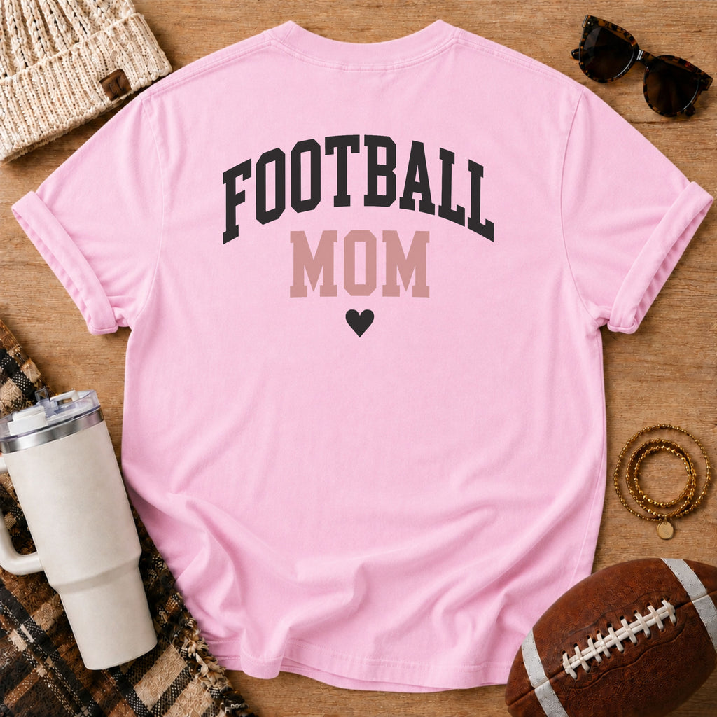 FOOTBALL MOM graphic shirt in light pink, Comfort Colors Blossom, shown in a styled flat lay from the back.