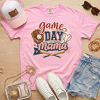 Game Day Mama baseball mom Comfort Colors tee in blossom light pink flat lay with trucker hat, denim shorts, white sneakers, and baseball.
