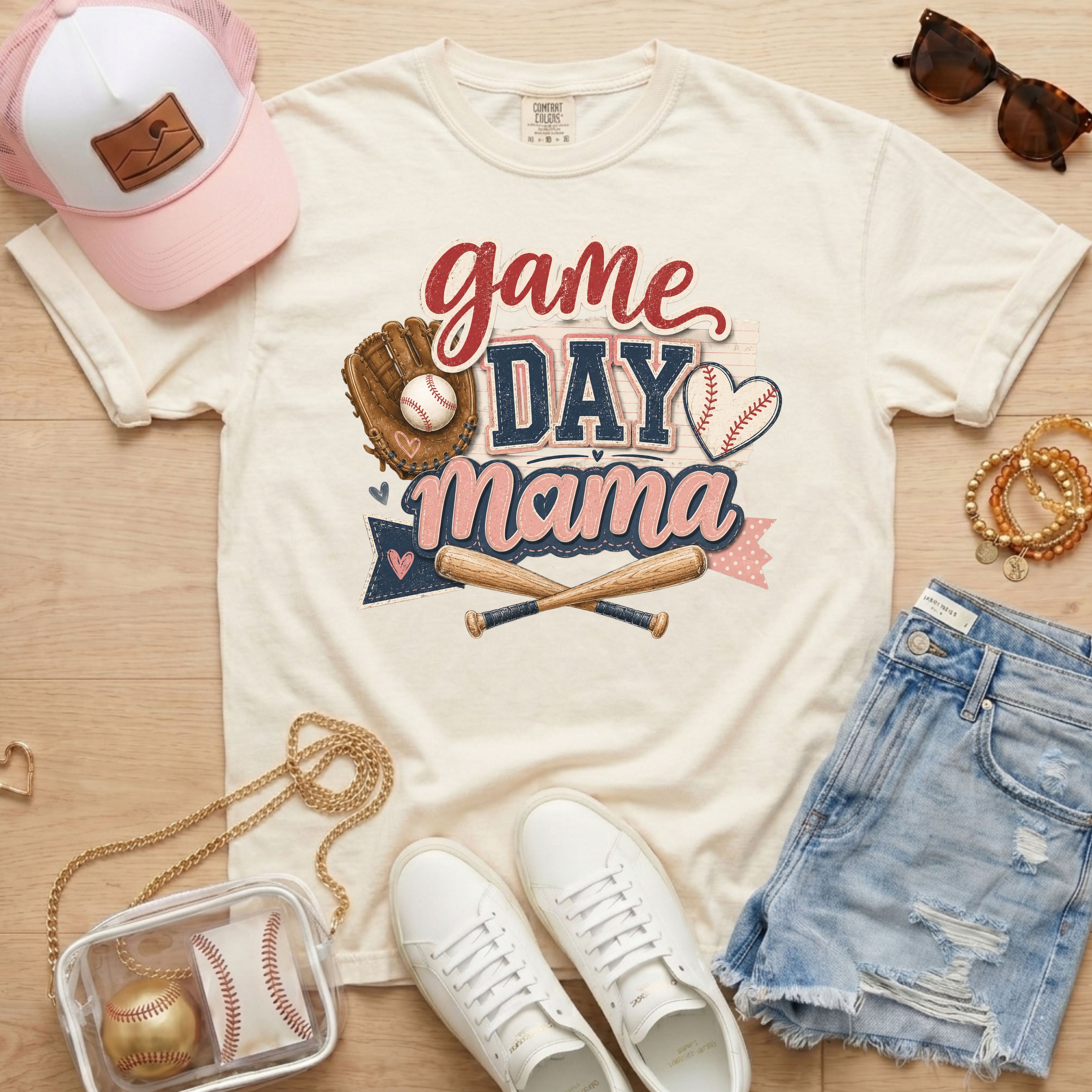 Game Day Mama baseball mom Comfort Colors tee in ivory flat lay with trucker hat, denim shorts, white sneakers, and baseball.