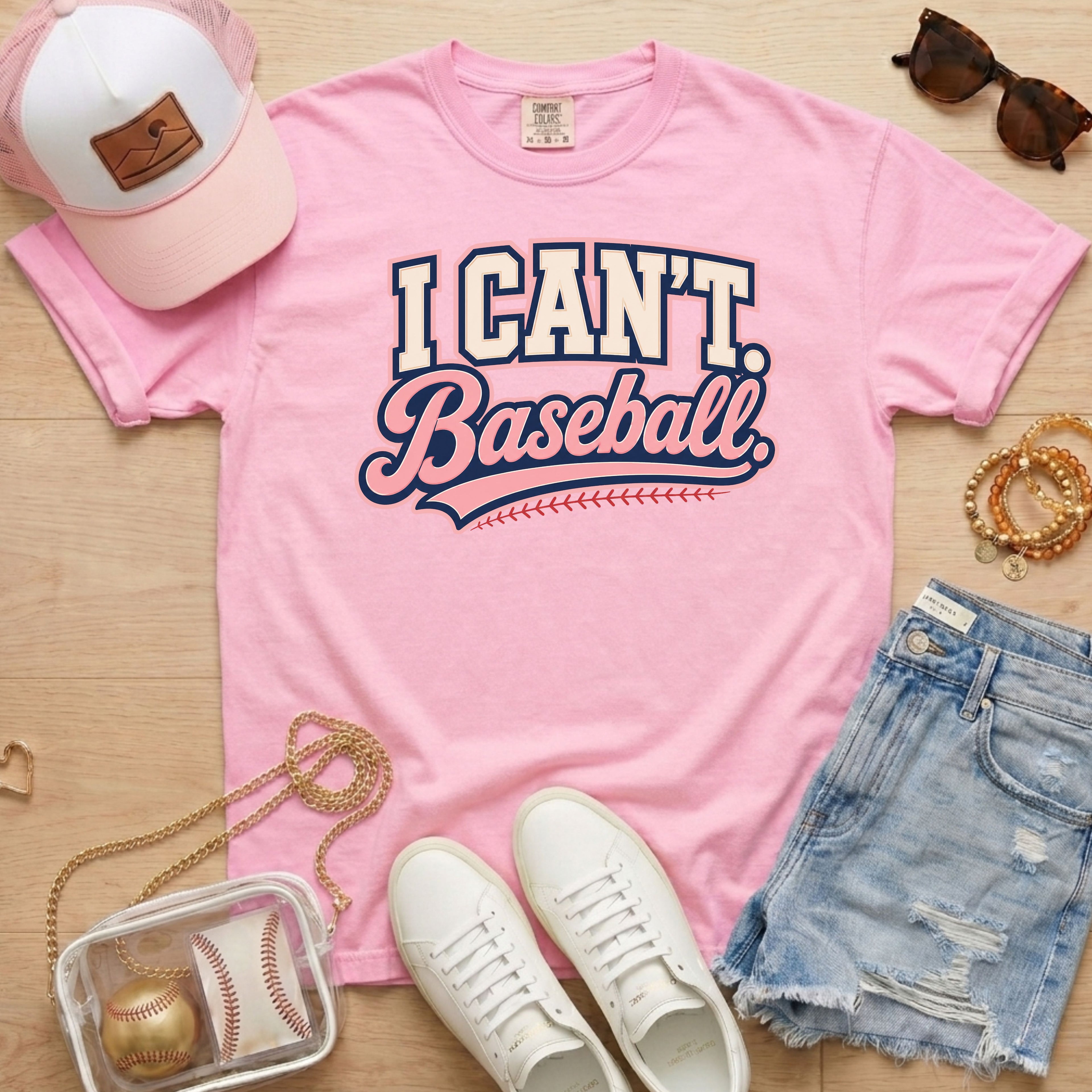 I CAN'T. Baseball. baseball mom Comfort Colors blossom tee in a flat lay with pink hat, sneakers, denim shorts, and baseball bag.