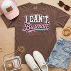 I CAN'T. Baseball. baseball mom Comfort Colors espresso tee in a boutique game day flat lay with hat, sneakers, denim shorts, and baseball bag.