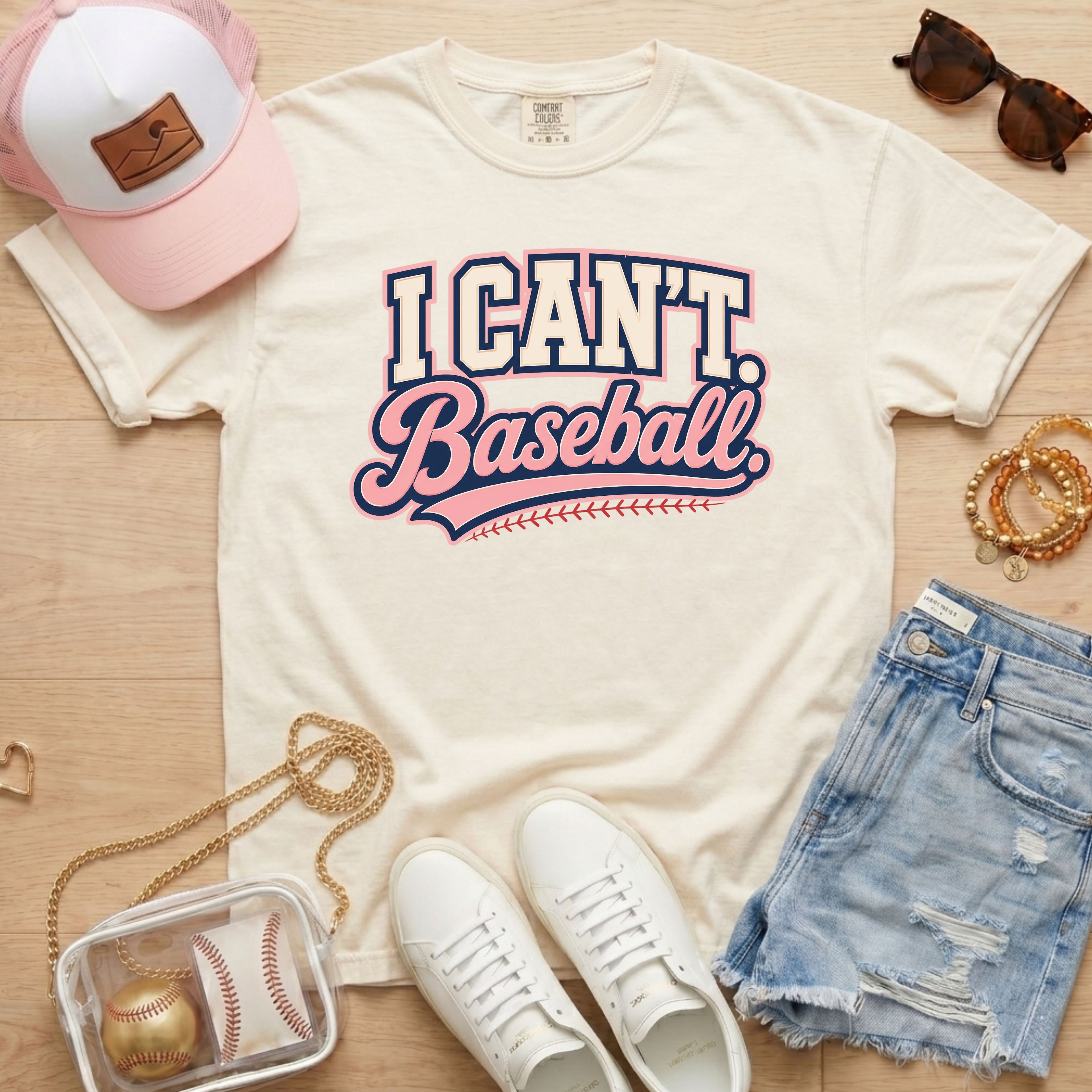 I CAN'T. Baseball. baseball mom Comfort Colors ivory tee in a flat lay with pink hat, sneakers, denim shorts, and baseball bag.