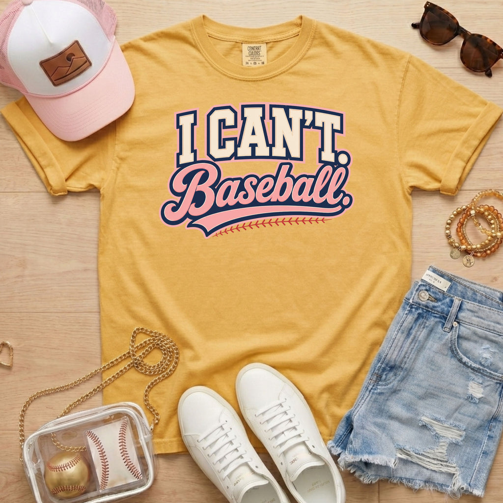 I CAN'T. Baseball. baseball mom Comfort Colors mustard tee in a flat lay with hat, sneakers, denim shorts, and baseball bag.