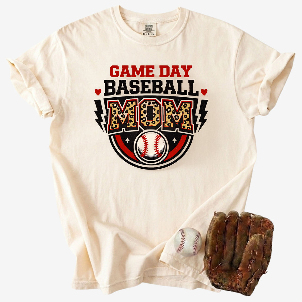 Beige t-shirt with 'Game Day Baseball Mom' design, baseball, and glove on a white background