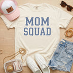 mom squad baseball mom shirt on ivory comfort colors tee styled with hat and denim shorts