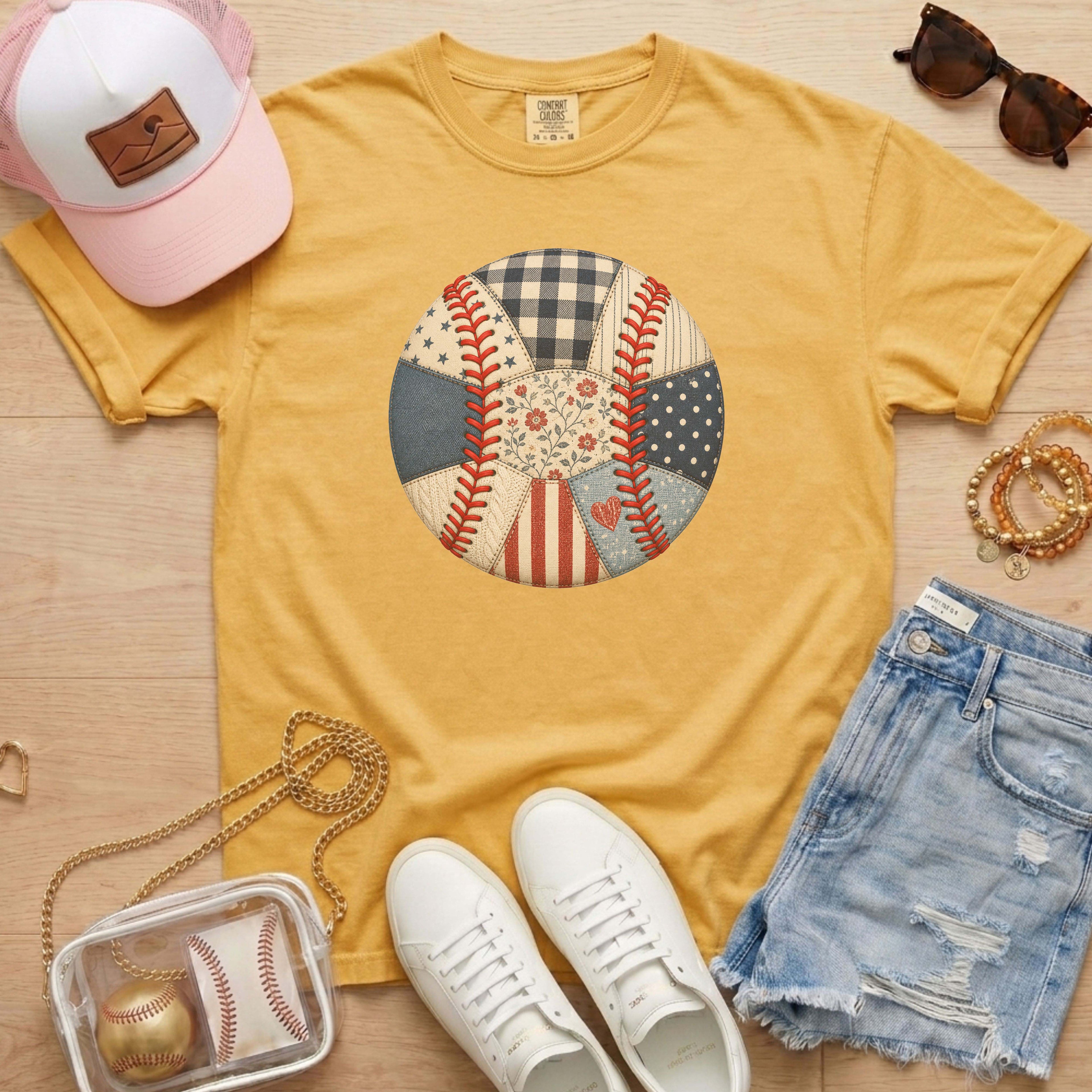 Yellow t-shirt with baseball design, white sneakers, pink cap, sunglasses, and denim shorts on a wooden surface.