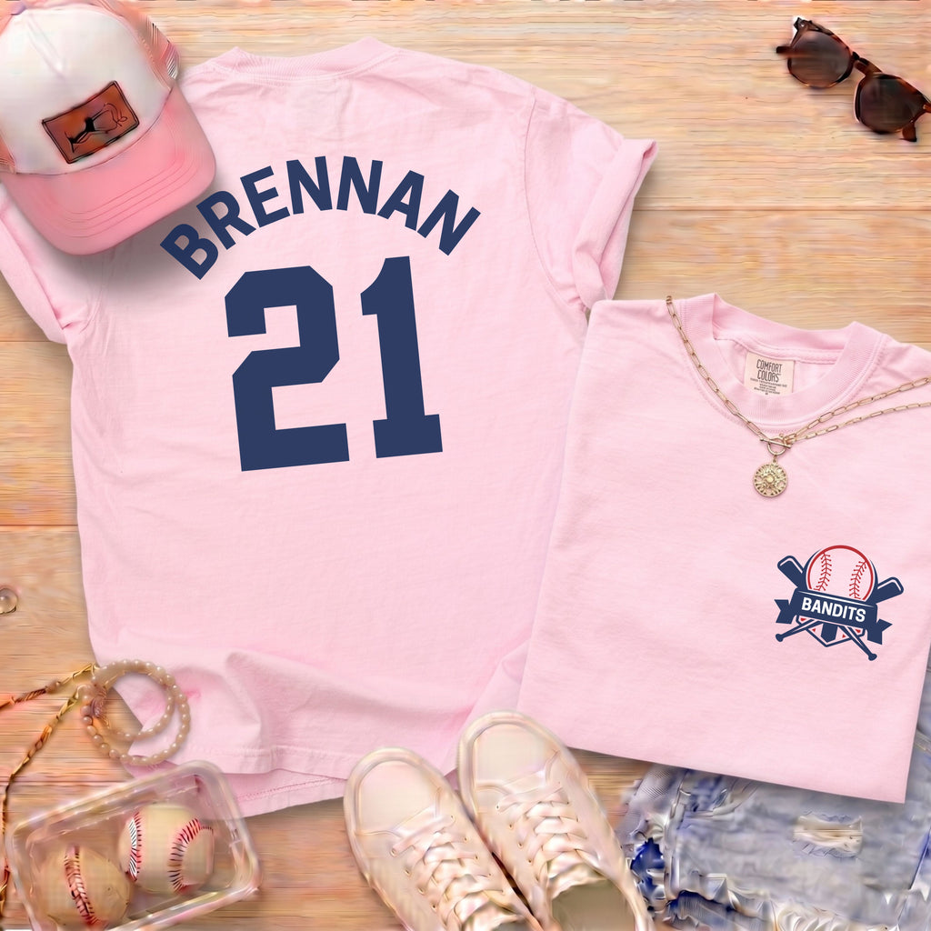 Pink Comfort Colors 1717 shirt featuring custom baseball player name Brennan 21 and Bandits logo on pocket area