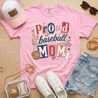Proud baseball mom Comfort Colors blossom pink game day tee flat lay with hat sunglasses and accessories