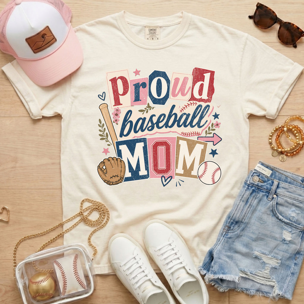 Proud baseball mom Comfort Colors ivory game day tee flat lay with hat sunglasses and denim shorts