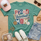 Proud baseball mom Comfort Colors light green game day tee lifestyle flat lay with accessories