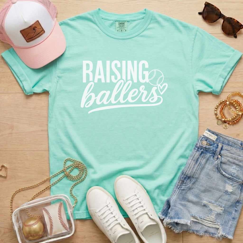 Raising Ballers baseball mom Comfort Colors chalky mint game day tee styled with hat, denim shorts, and baseball accessories