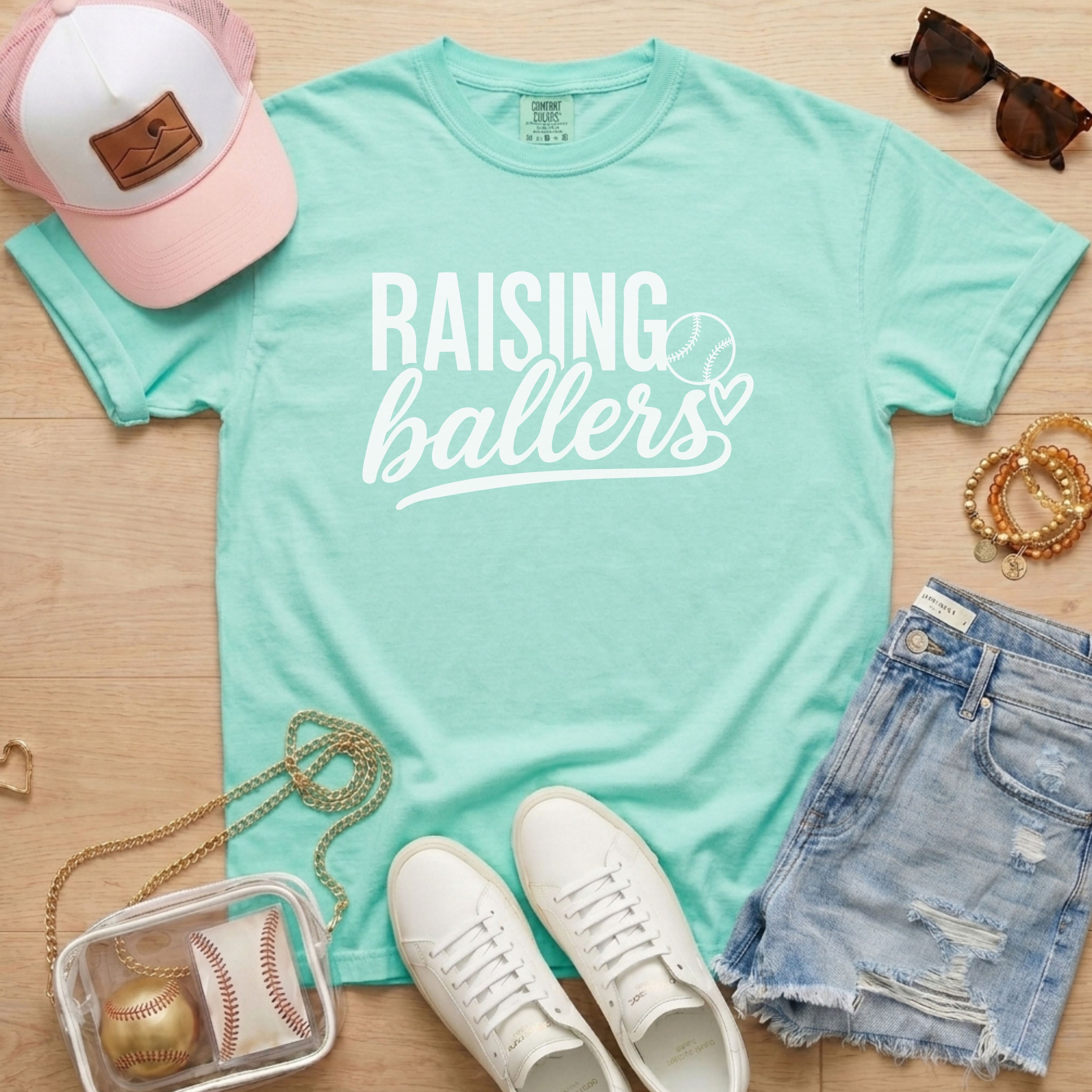 Raising Ballers baseball mom Comfort Colors chalky mint game day tee styled with hat, denim shorts, and baseball accessories