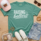 Raising Ballers baseball mom Comfort Colors light green game day tee styled with hat, denim shorts, and baseball accessories