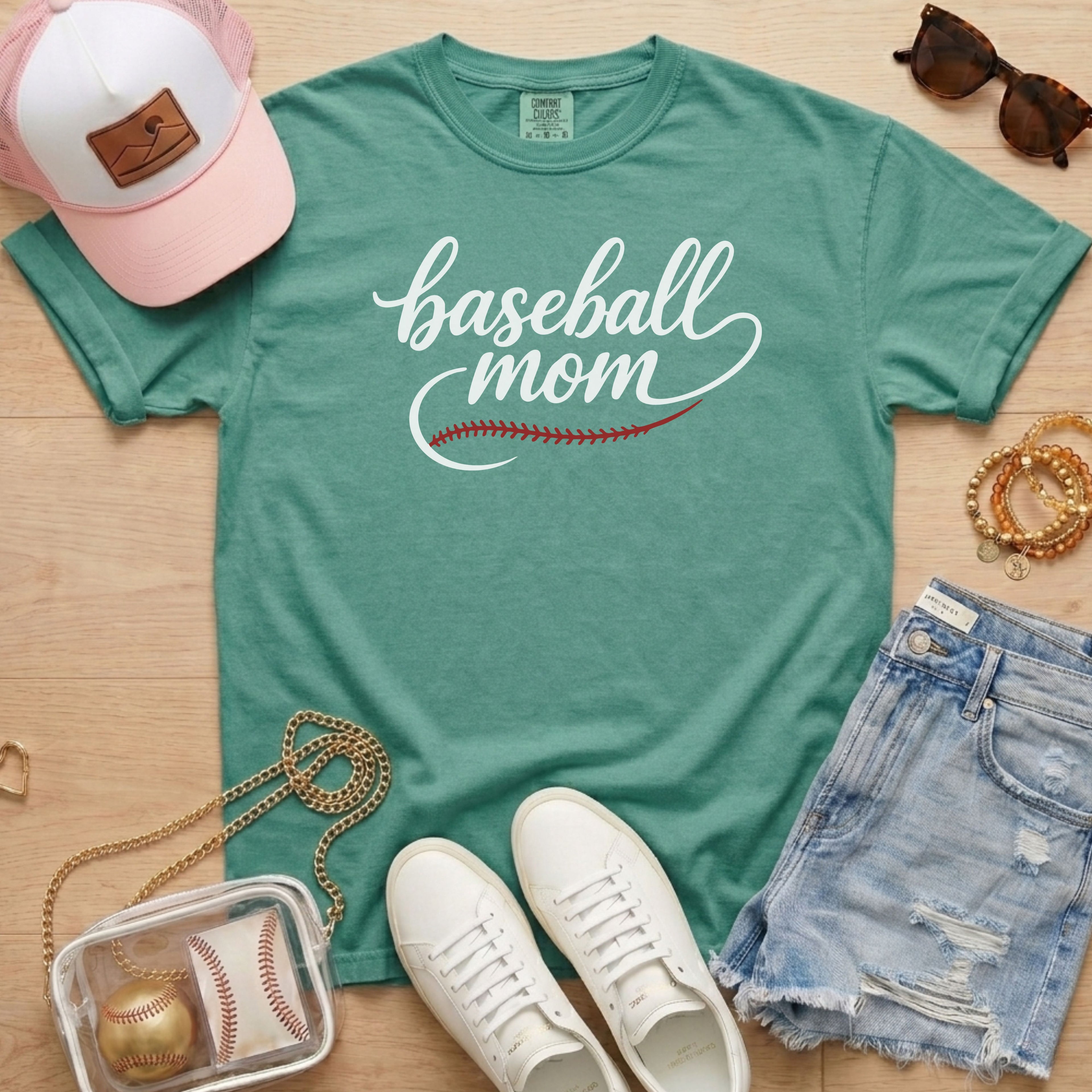 light green Comfort Colors shirt featuring script Baseball Mom text and red stitch detail for baseball moms