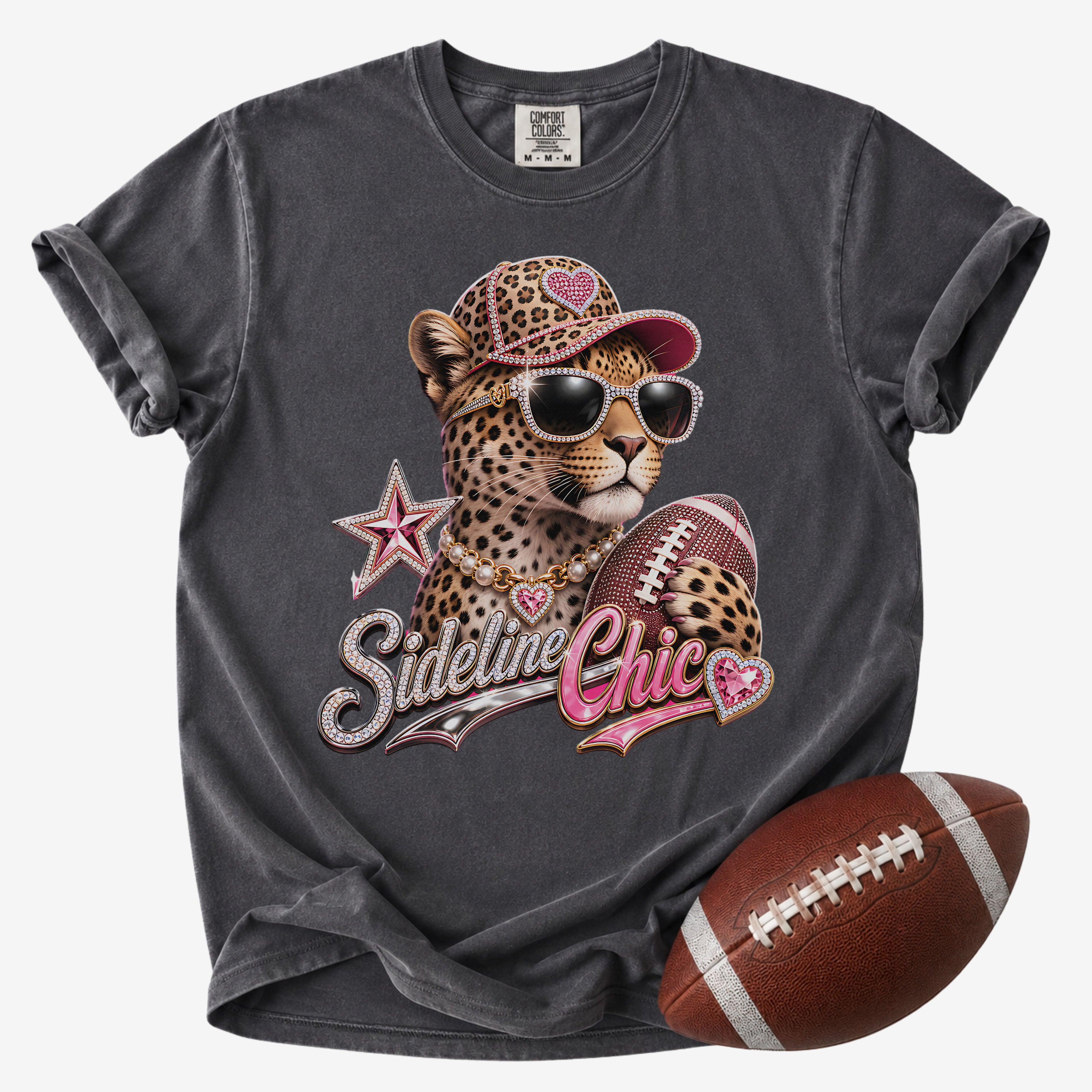 Football mom graphic T-shirt in charcoal gray, Comfort Colors Pepper, featuring a leopard in sunglasses holding a football with jeweled “Sideline Chic” lettering.
