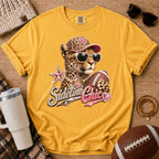 Golden yellow football mom graphic T-shirt, Comfort Colors Mustard, styled in a game day flat lay with the jeweled leopard “Sideline Chic” design.