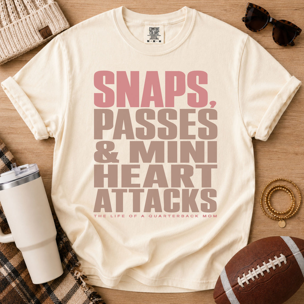 Cream quarterback mom shirt, Comfort Colors Ivory, styled in a game day flat lay with a football, tumbler and retro typography design.