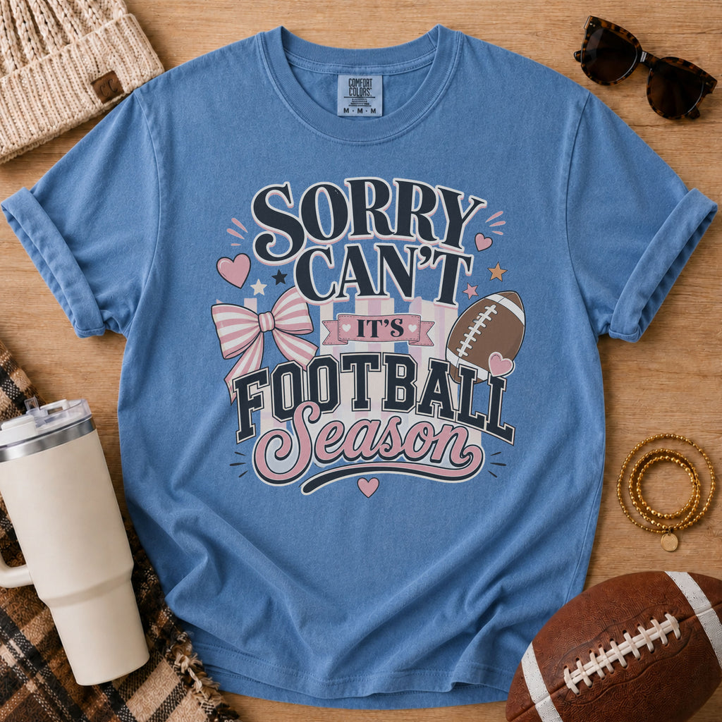 Blue Jean Comfort Colors football mom shirt with pink bow football season design for game day.