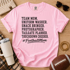 Super Football Mom football mom Comfort Colors tee in Blossom pink, flat lay with a football and tumbler