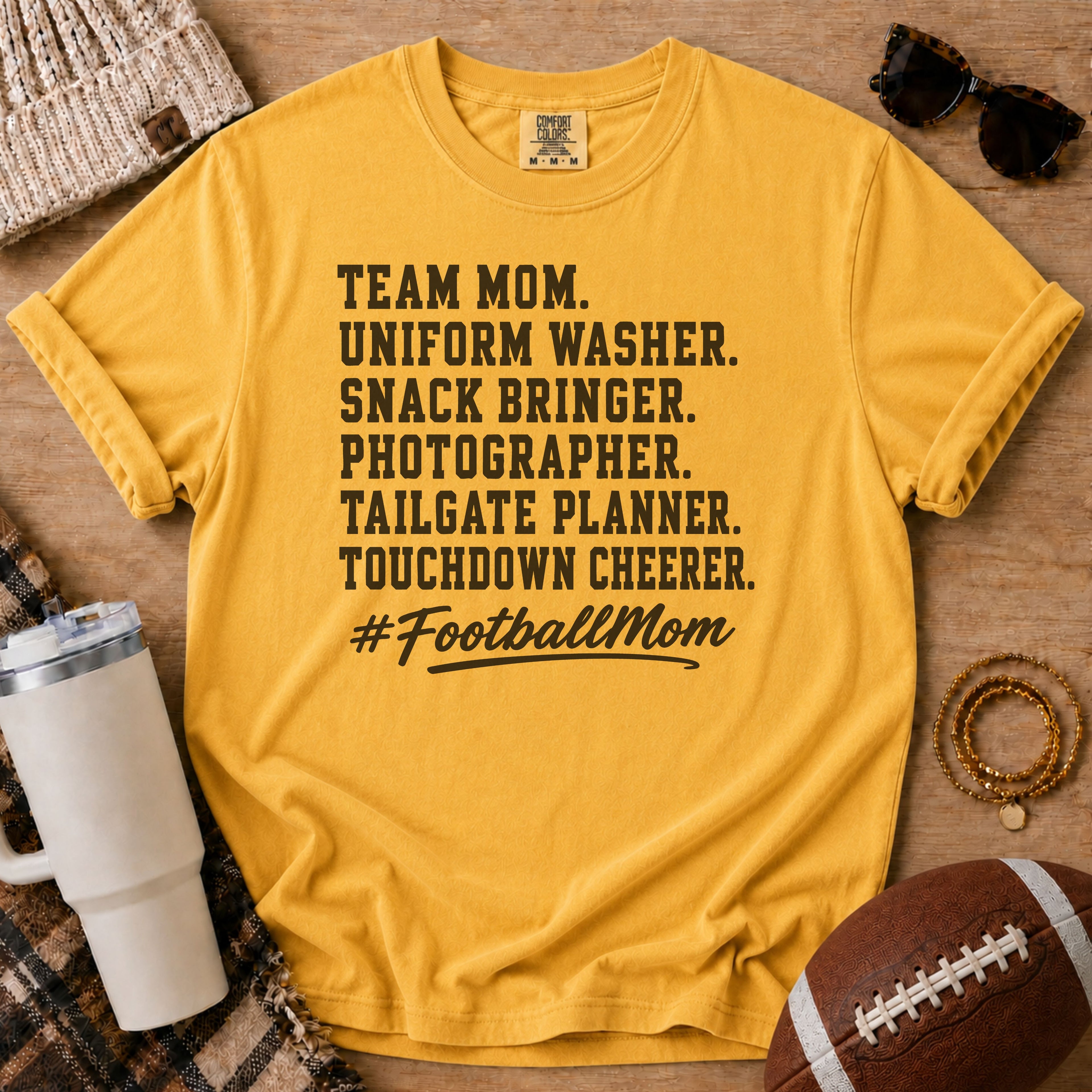 Super Football Mom football mom Comfort Colors tee in Mustard gold, styled with a football and tumbler