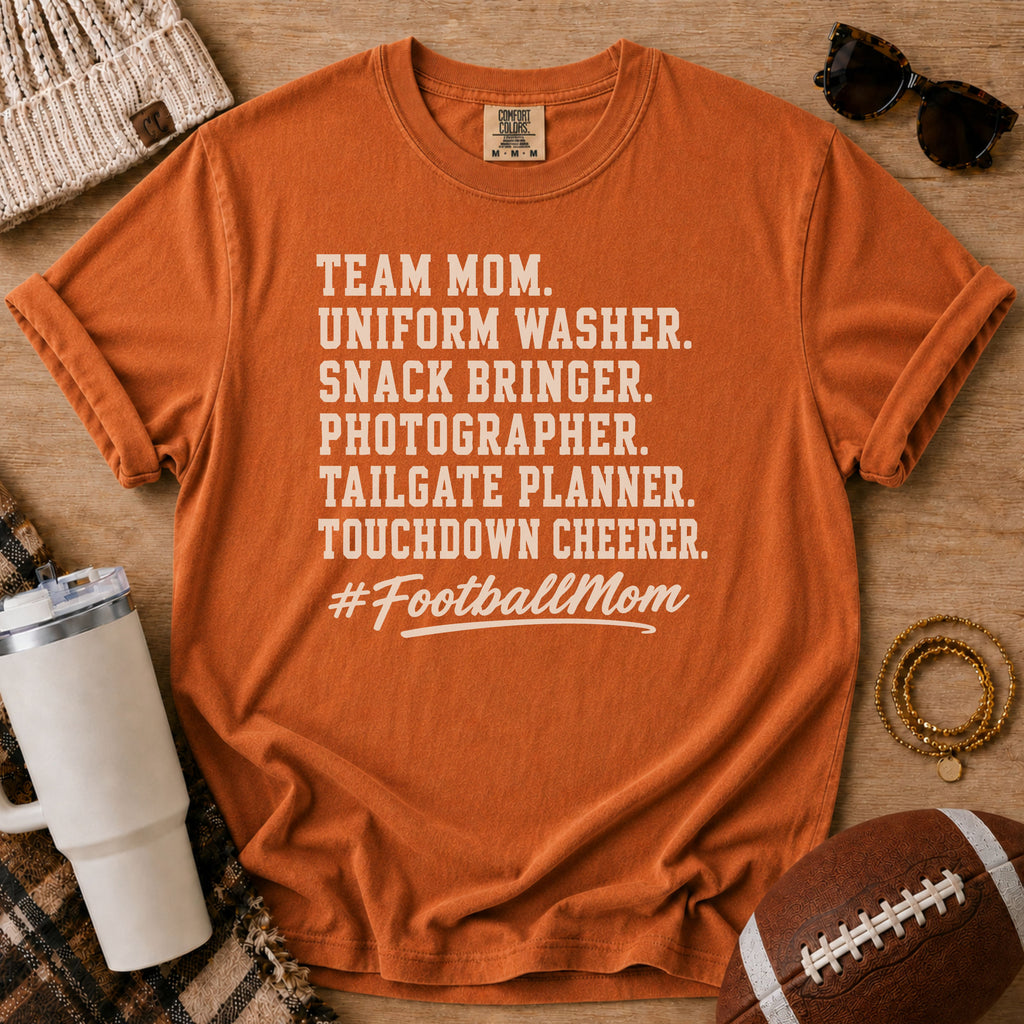 Super Football Mom football mom Comfort Colors tee in Yam orange, styled with a football and tumbler
