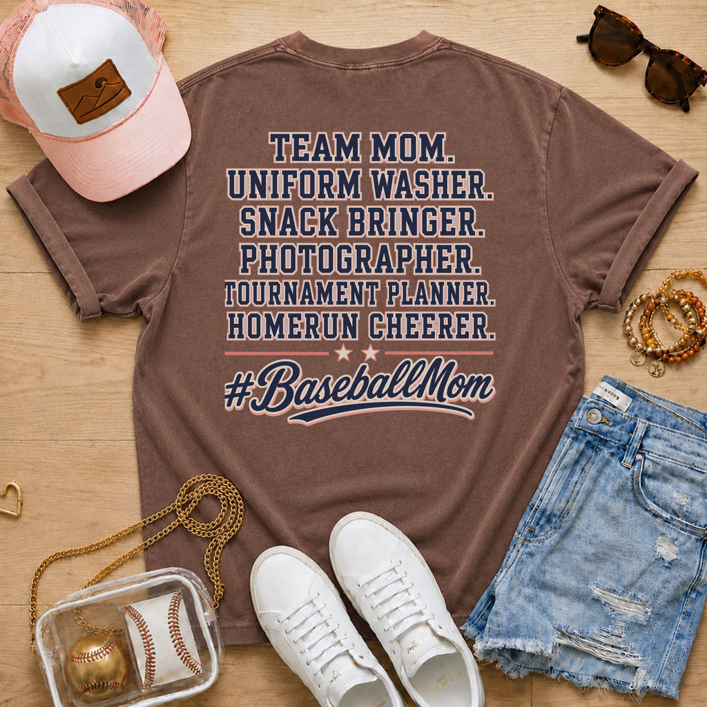 Team Mom Uniform Washer Snack Bringer baseball mom Comfort Colors Espresso tee flat lay with pink trucker hat, baseball purse, white sneakers, denim shorts, sunglasses, and jewelry.