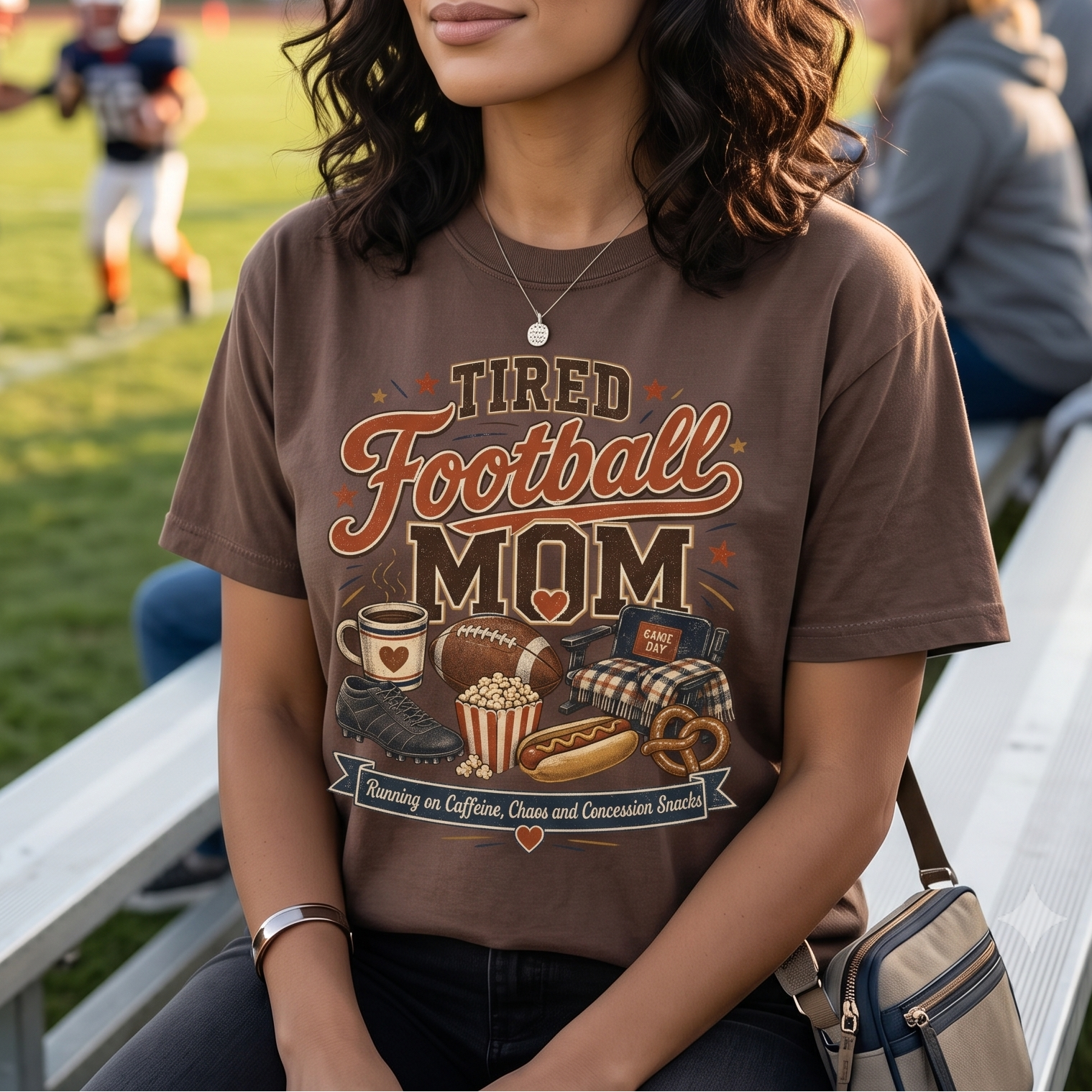 Football mom wearing an Espresso tired football mom shirt on the bleachers during a youth football game.